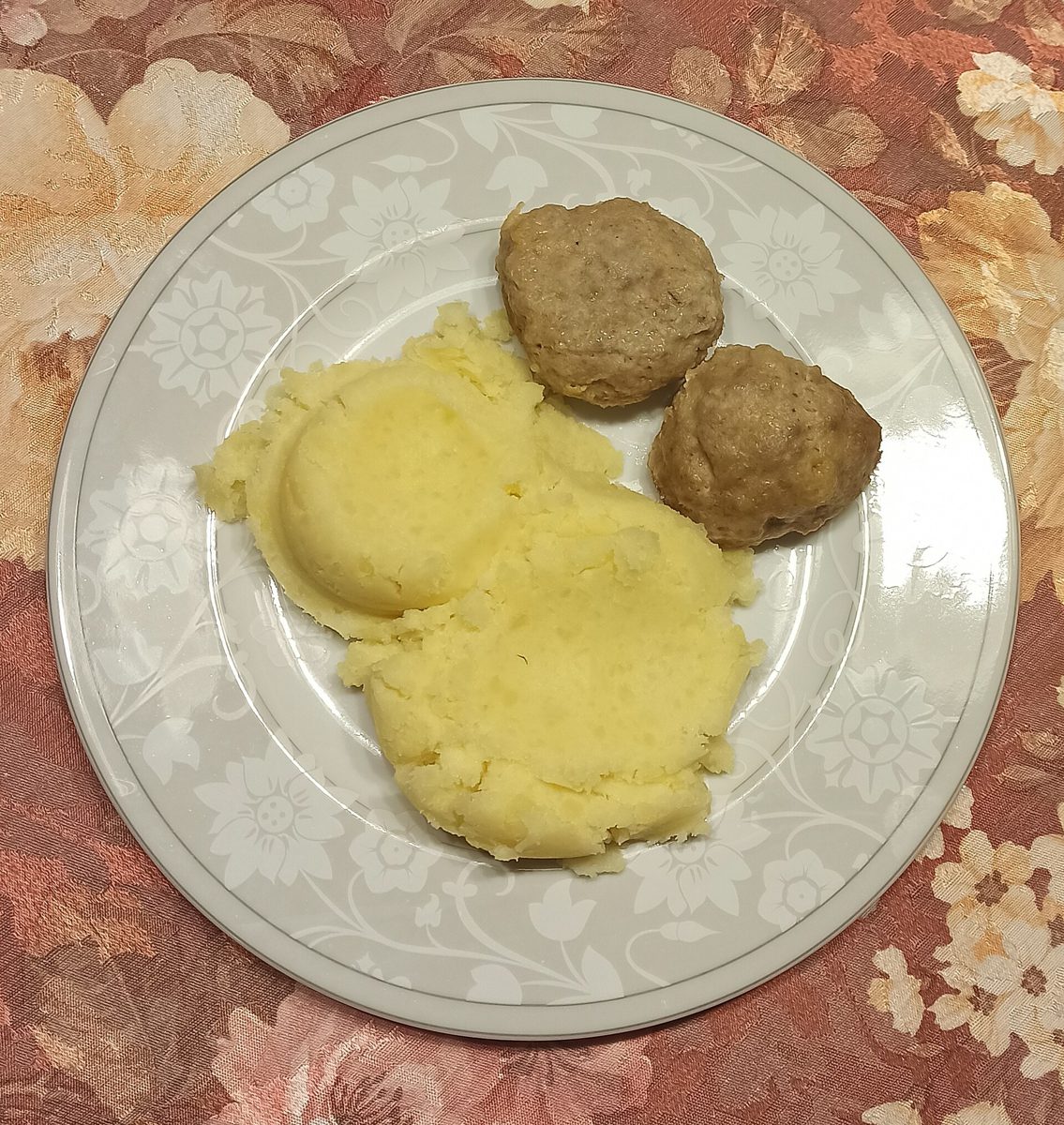 Dwa pulpety indyczo-wieprzowe z puree ziemniaczanym na talerzu